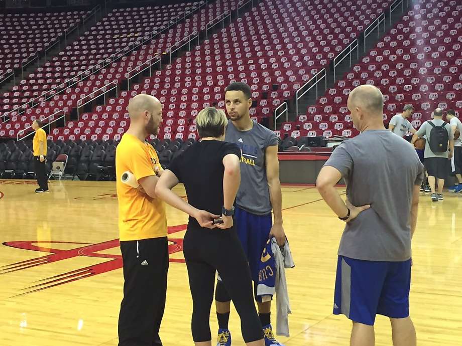 Warriors guard Stephen Curry talks to team trainers Thursday in Houston. Soon after the decision was made not to have the reigning MVP play in Game 3