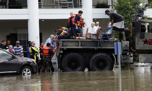 DAVID J. PHILLIP						Credit AP				Residents are evacuated from a retirement and assisted-living complex as floodwaters rise Tuesday in Spring Texas