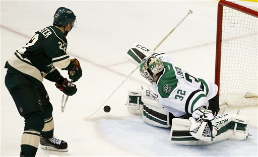 Dallas Stars goalie Kari Lehtonen swats away a shot by Minnesota Wild right wing Nino Niederreiter during the second period of Game 6 in the first round of the NHL Stanley Cup playoffs in St. Paul Minn. Sunday