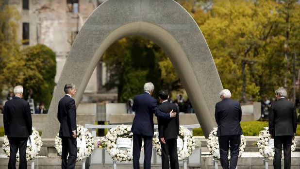 U.S. Secretary of State John Kerry puts his arm around Japan's Foreign Minister Fumio Kishida after they and fellow G7 foreign ministers laid wreaths at the cenotaph at Hiroshima Peace Memorial Park and Museum in Hiroshima Japa