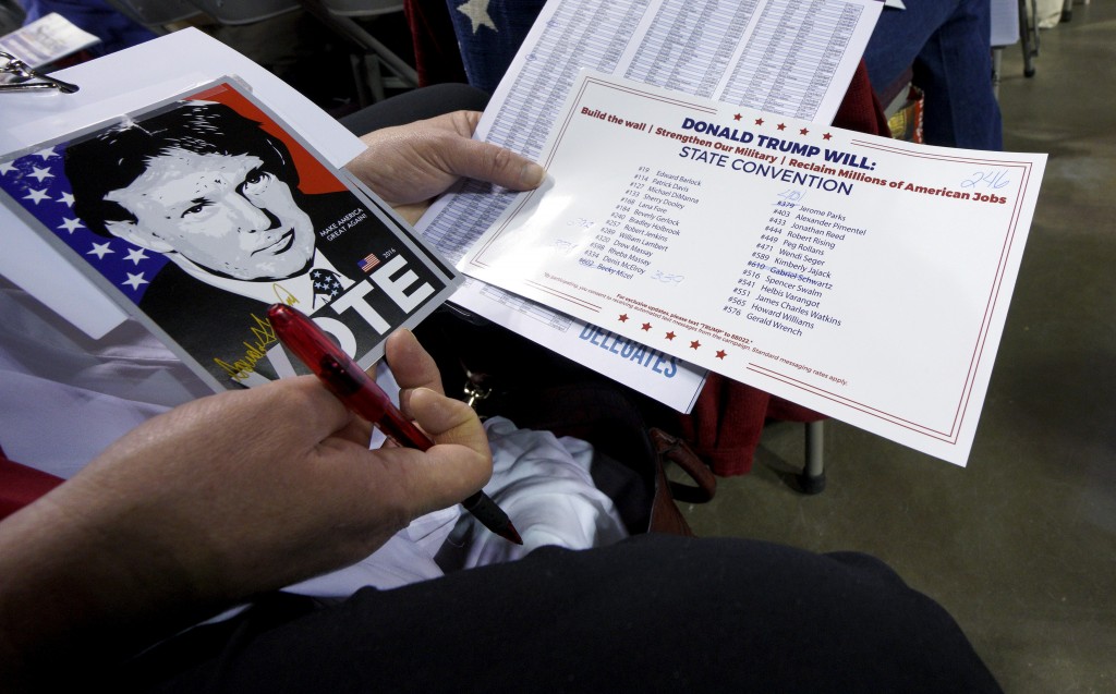 A delegate supporting Republican presidential candidate Donald Trump looks over documents at the Colorado Republican state convention in Colorado Springs Colorado