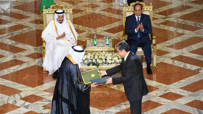 2016 shows Egyptian President Abdel Fattah al Sisi and Saudi King Salman bin Abdulaziz applauding during a ceremony for the signing of bilateral agreements at the Presidential Palace in Cairo