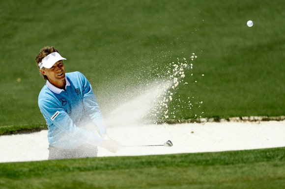 Bernhard Langer plays a bunker shot during his third round at Augusta last night. The 58-year-old German rolled back the years to post a round of 70 to go into the final round just two strokes behind Jordan Spieth