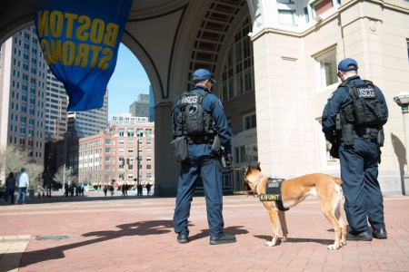 Petty Officers Craig Oravitz and Richard Barone patrol Boston’s waterfront with Rruthie a specially trained Coast Guard dog Sunday