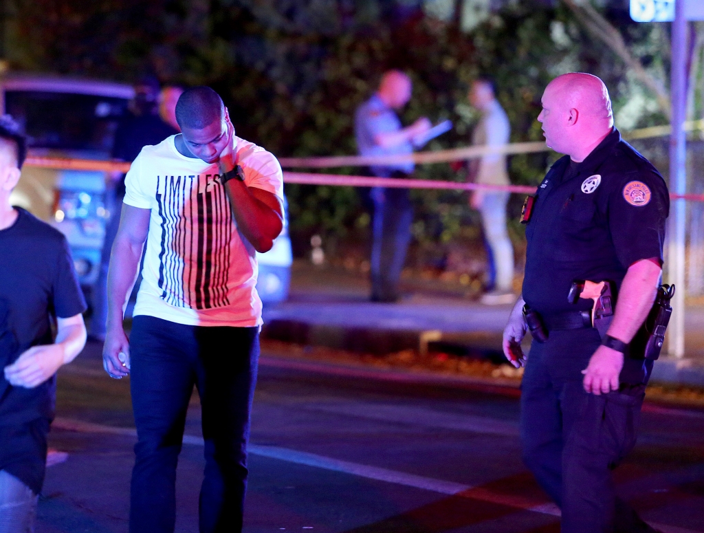 Former New Orleans Saints running back Pierre Thomas walks early Sunday near the scene of a deadly shooting Saturday night