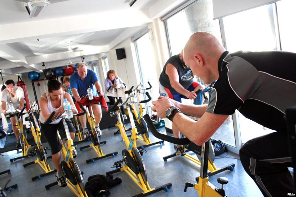 FILE People are seen exercising in a spinning class. A new study claims short intense exercise is as good as longer moderate exercise