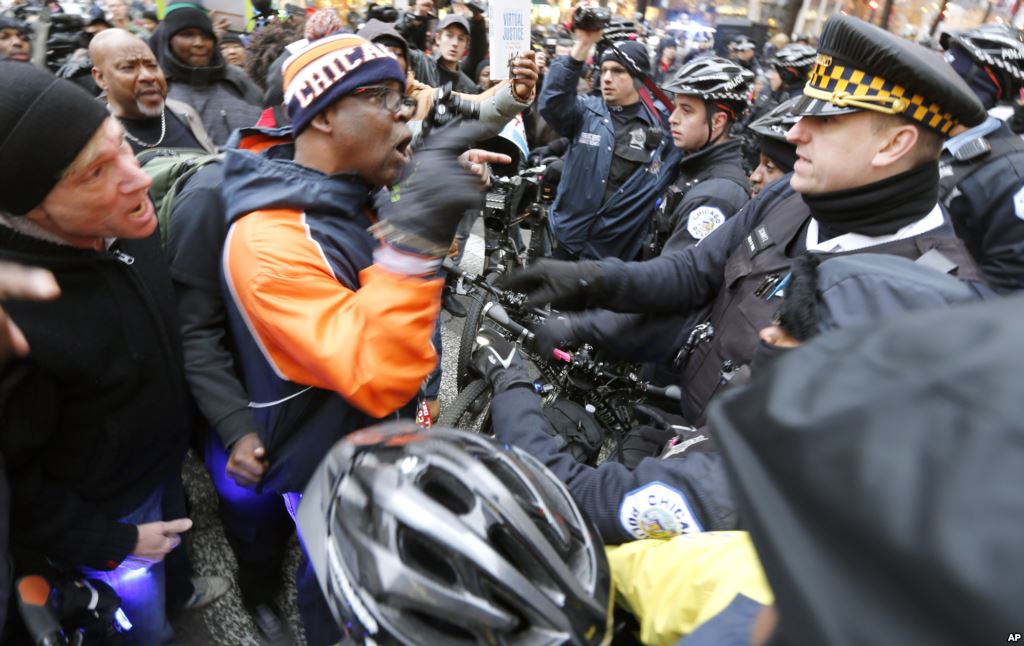 FILE- Protesters confront Chicago police during a march against police violence in Chicago Illinois Dec. 24 2015