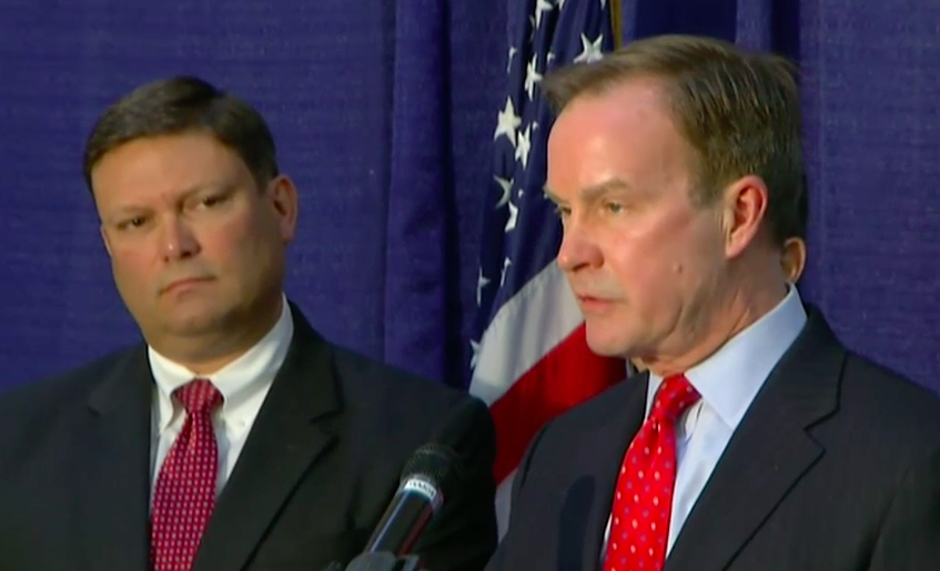 Michigan Attorney General Bill Schuette speaks at a press conference in Lansing Wednesday flanked by Andy Arena former director of the Detroit FBI office working as chief investigator in the Flint water case