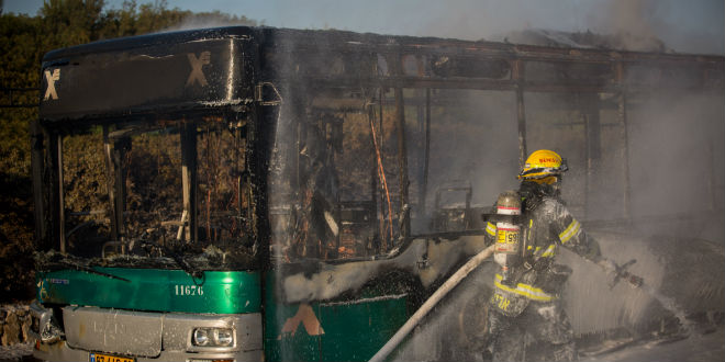 Firefighters and rescue personnel at the scene of a bus bombing in Jerusalem