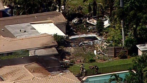 Firefighters put out flames at Pompano Beach Fla. home where a small plane crashed Monday