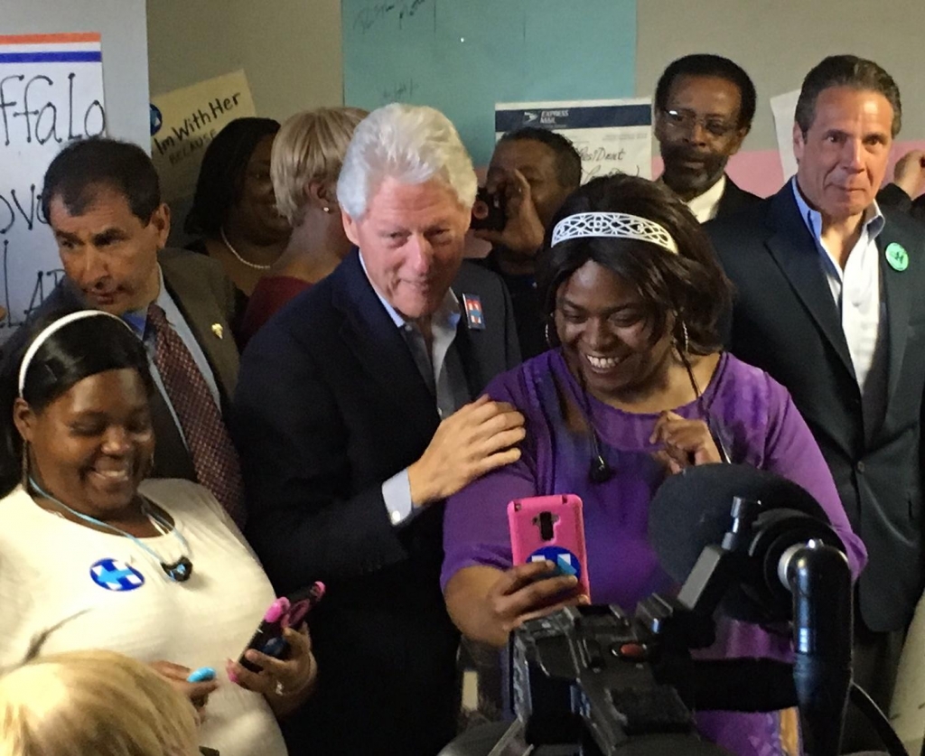 Former Pres. Bill Clinton stops for a selfie during a get-out-the-vote stop in Buffalo