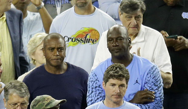 Former UNC great Michael Jordan right watches the NCAA title game in Houston Monday