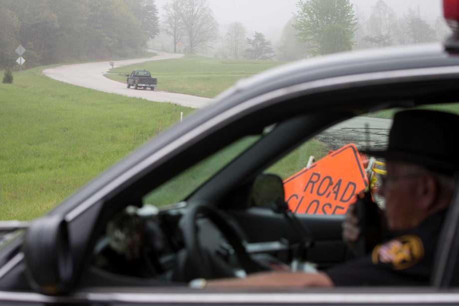 Leonard Manley left father and grandfather of several murder victims drives up Union Hill Road away from a roadblock at the outer perimeter of a crime scene Wednesday