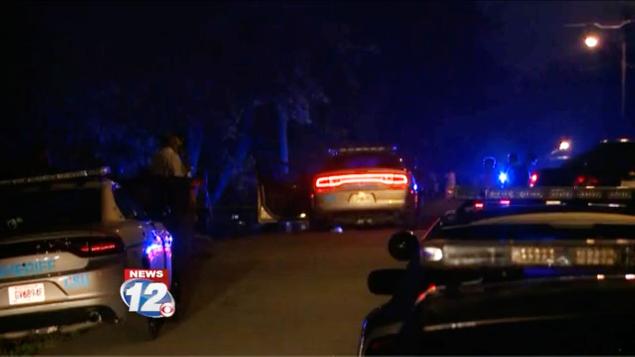 Police secure the scene on Johnson Drive in Appling Georgia on Friday night after three people were shot to death there. Two others were killed about a mile away