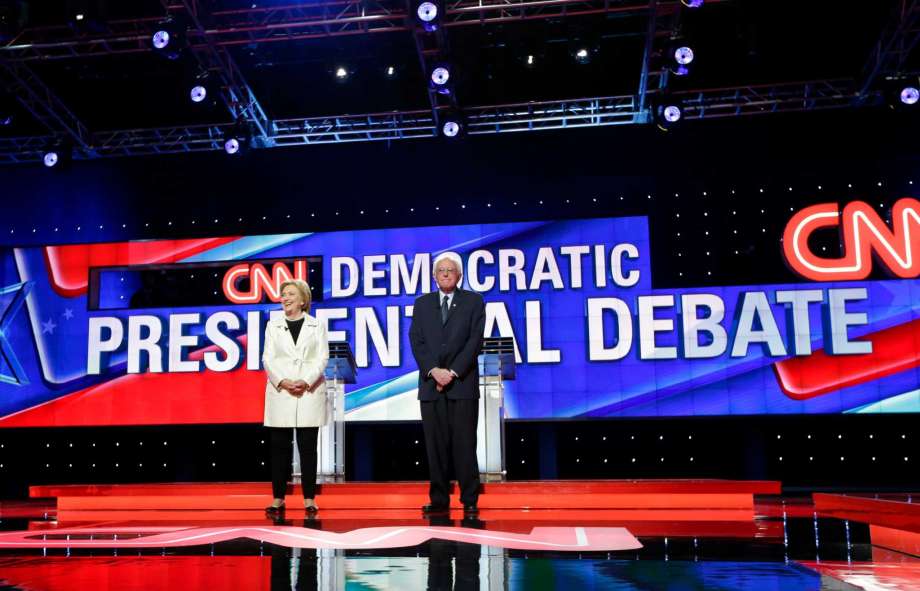 Democratic presidential candidates Sen. Bernie Sanders I-Vt. right and Hillary Clinton stand on stage before the CNN Democratic Presidential Primary Debate at the Brooklyn Navy Yard Thursday