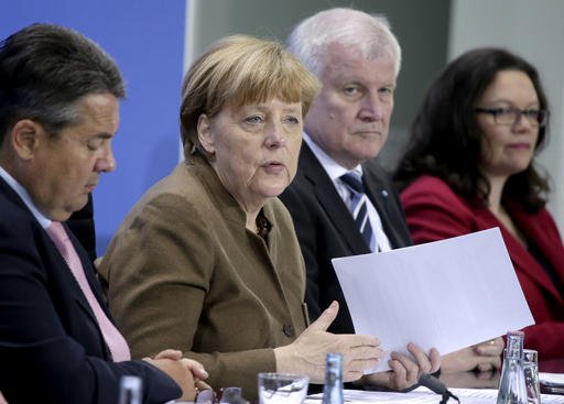 From left Sigmar Gabriel Chairman of the German Social Democrats German Chancellor Angela Merkel Horst Seehofer Chairman of the German Christian Social Union and German Labor Minister Andrea Nahles address the media during a press conference in Berli