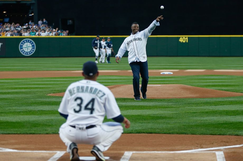 SEATTLE WA- APRIL 08 Former Mariners great Ken Griffey Jr. throws out the ceremonial first pitch to Felix Hernandez #34 prior to the Mariners home opener against the Oakland Athletics at Safeco Field