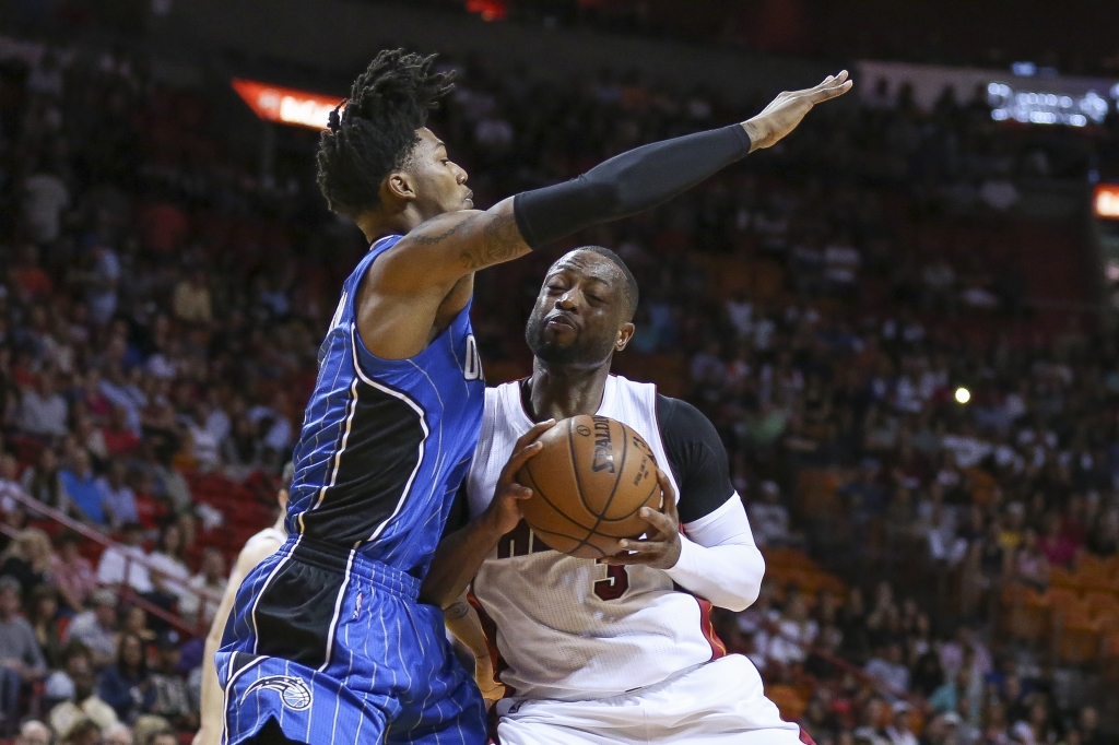 Miami Heat's Dwyane Wade gets blocked by Orlando Magic's Elfrid Payton during the first quarter on Sunday