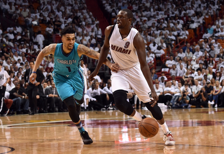 Apr 17 2016 Miami FL USA Miami Heat forward Luol Deng dribbles the ball as Charlotte Hornets guard Courtney Lee defends during the second half in game one of the first round of the NBA Playoffs at American Airlines Arena. The Heat won 123-91