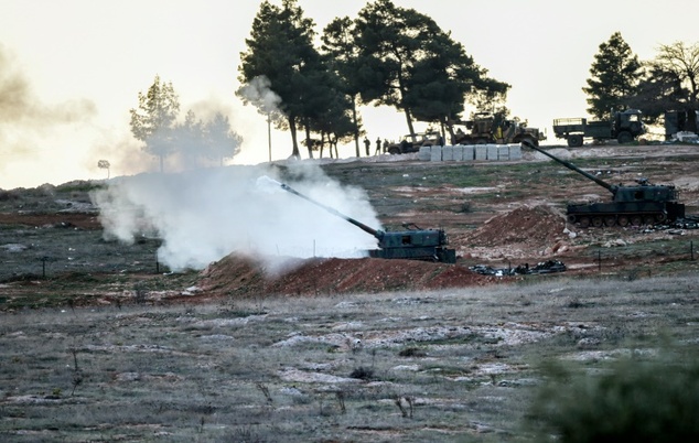 Tanks stationed at a Turkish army position near the Oncupinar crossing gate close to the Turkish border town of Kilis fire towards the Syria border on Febr