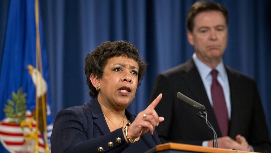 Attorney General Loretta Lynch accompanied by FBI Director James Comey speaks during a news conference at the Justice Department in Washington Thursday