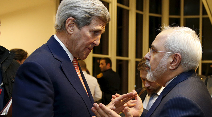 U.S. Secretary of State John Kerry talks with Iranian Foreign Minister Javad Zarif after the International Atomic Energy Agency verified that Iran has met all conditions under the nuclear deal in Vienna