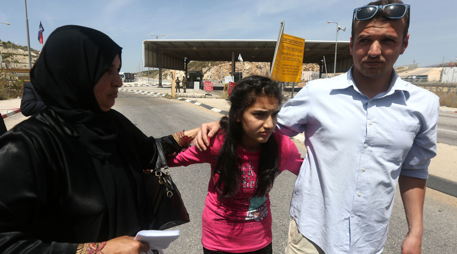 The mother and brother of Palestinian Dima al-Wawi 12 who is believed to be the youngest female detained by Israel greet her in the West Bank city of Tulkarem upon her release from Israeli prison