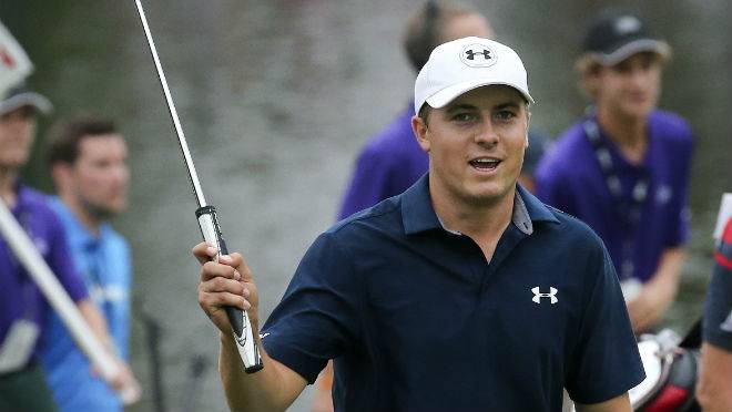 Jordan Spieth waves to the crowd as he walks to the 18th green before winning the Tour Championship golf tournament and the Fed Ex Cup at East Lake Golf Club in Atlanta