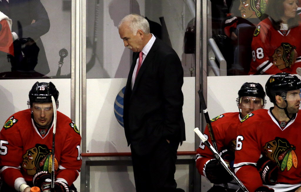 Joel Quenneville looks down as he watches his team during the third period in Game 3