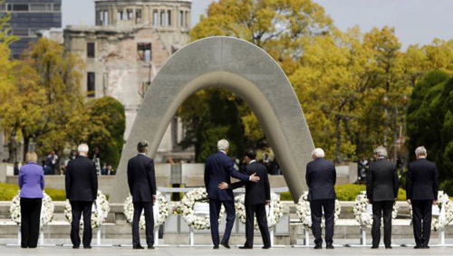 U.S. Secretary of State John Kerry puts his arm around Japans Foreign Minister Fumio Kishida after they and fellow G7 foreign ministers laid wreaths at the cenotaph at Hiroshima Peace Memorial Park in Hiroshima western Japan