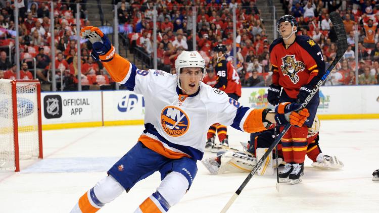 New York Islanders left winger Brock Nelson celebrates his first period goal as Florida Panthers defenseman Dmitry Kulikov reacts in game one of the first round of the 2016 Stanley Cup Playoffs at BB&T Center