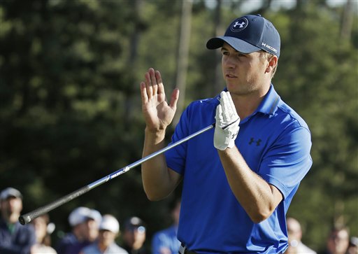 Jordan Spieth indicates how far he miss a putt for par on the 17th green on the during the second round of the Masters golf tournament Friday