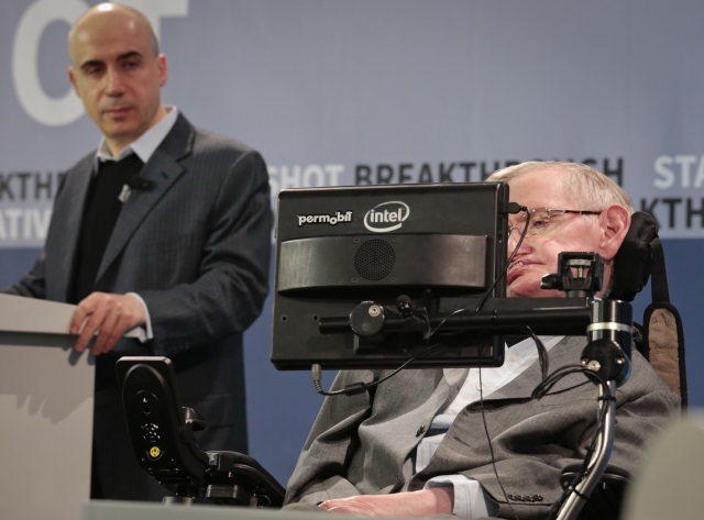 Internet investor and science philanthropist Yuri Milner left listens as renowned cosmologist Stephen Hawking right speaks with the assistance of adaptive speech technology during a press conference announcing the new Breakthrough Initiative focusing