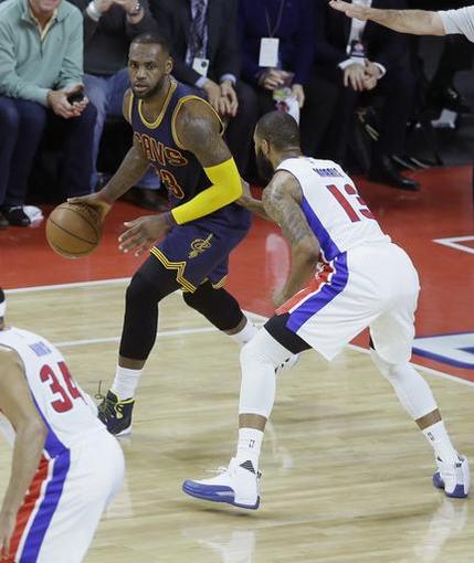 Cleveland Cavaliers forward Le Bron James looks to pass around Detroit Pistons forward Marcus Morris during the first half in Game 3 of a first-round NBA basketball playoff series Friday