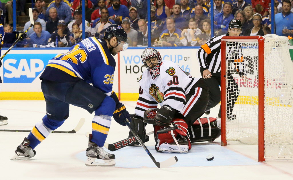 Blues right wing Troy Brouwer scores the game-winning goal past Blackhawks goaltender Corey Crawford in the third period during Game 7 of their first-round playoff series at Scottrade Center