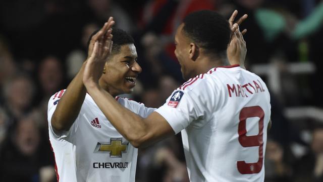 Marcus Rashford celebrates with Anthony Martial after scoring the first goal for Manchester United