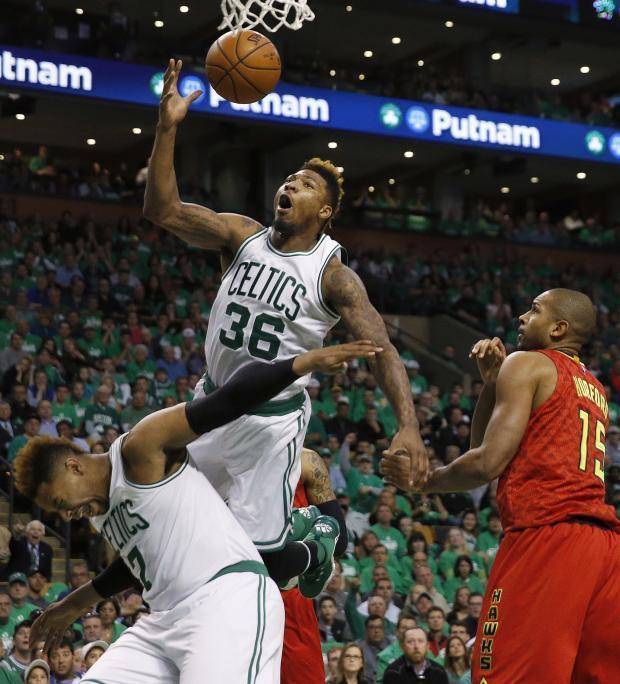 Marcus Smart lands on teammate Jared Sullinger after being fouled Sunday against Atlanta