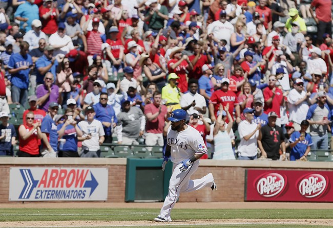 Fans cheer as Texas Rangers designated hitter Prince Fielder rounds the bases after hitting a three-run home run during the sixth inning of a baseball game against the Seattle Mariners Wednesday