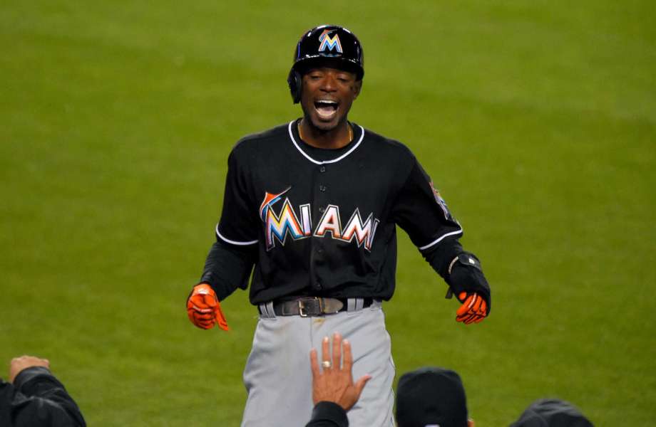 Miami Marlins Dee Gordon celebrates as he goes into the dugout after scoring on a balk by Los Angeles Dodgers relief pitcher Pedro Baez during the seventh inning of a baseball game Thursday