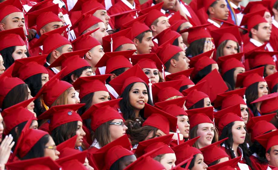 Odessa High School graduates pose for a group portrait prior to the start of the commencement ceremony in Odessa Texas. It’s not a promising