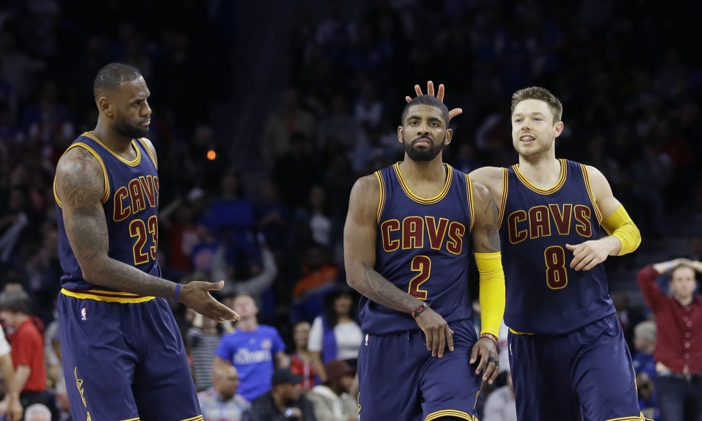 Cleveland Cavaliers guard Kyrie Irving is congratulated by guard Matthew Dellavedova and forward Le Bron James after a 3-point basket during the second half in Game 4 of a first-round NBA basketball playoff series Sunday