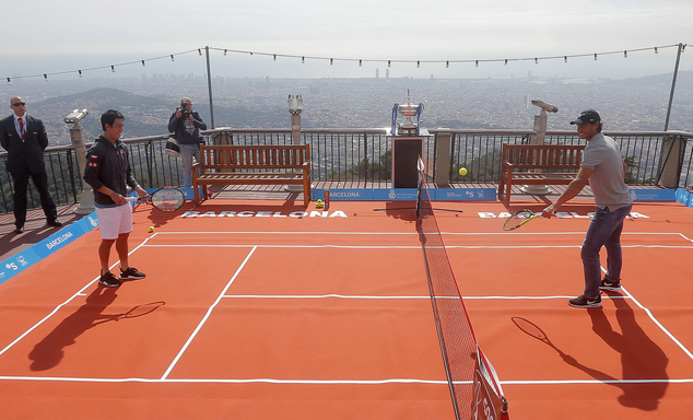 Spain's Rafael Nadal right and Kei Nishikori of Japan play a fun game of tennis ahead of the Barcelona Open tennis tournament at the Tibidabo park in Bar