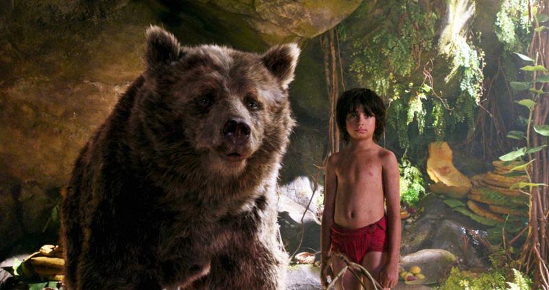 Neel Sethi right and Baloo the bear voiced by Bill Murray appear in a scene from the movie