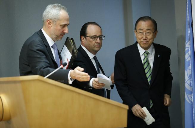 France's President Francois Hollande arrives with UN Secretary General Ban Ki-moon at the UN after the Opening Ceremony of the High Level Event for the Signature of the Paris Agreement