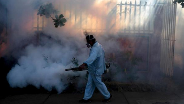 A health ministry worker fumigates a house to kill mosquitoes during a campaign against dengue and chikungunya and to prevent the entry of Zika virus in Managua Nicaragua Jan. 26 2016