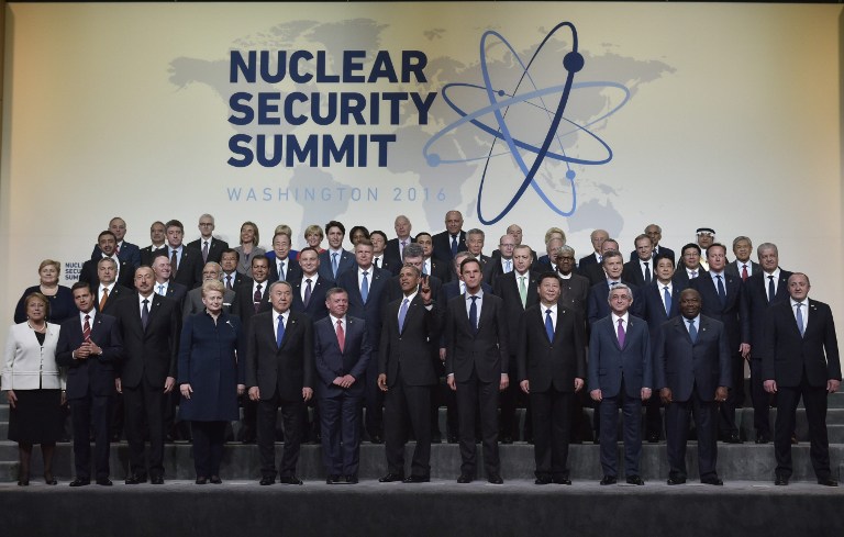 US President Barack Obama flashes a peace sign as he and other world leaders take part in the Nuclear Security Summit family