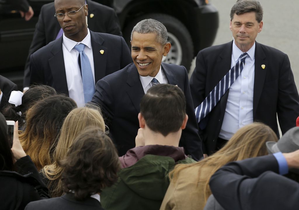 President Barack Obama smiles as he greets supporters after arriving on Air Force One at San Francisco International Airport in San Francisco Friday