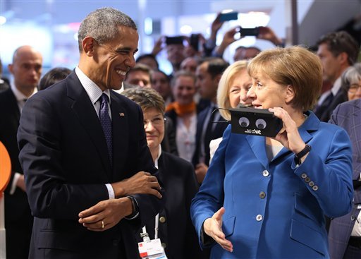 U.S. President Barack Obama left and German chancellor Angela Merkel test VR goggles when touring the Hannover Messe the world's largest industrial technology trade fair in Hannover northern Germany Monday