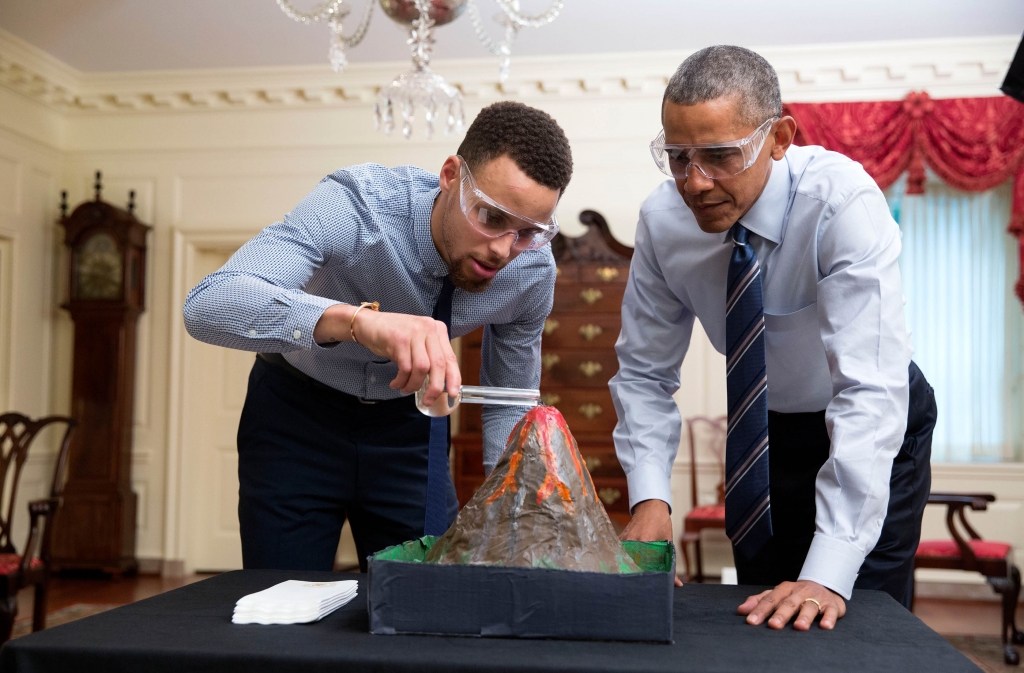 President Barack Obama wears protective glasses during a science experiment for a My Brother's Keeper taping with NBA player Stephen'Steph Curry in the Map Room of the White House Feb. 4 2016