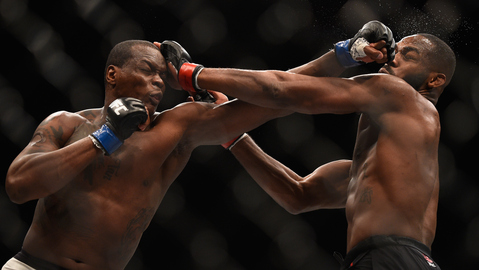 Ovince Saint Preux punches Jon Jones in their interim UFC light heavyweight championship bout during UFC 197